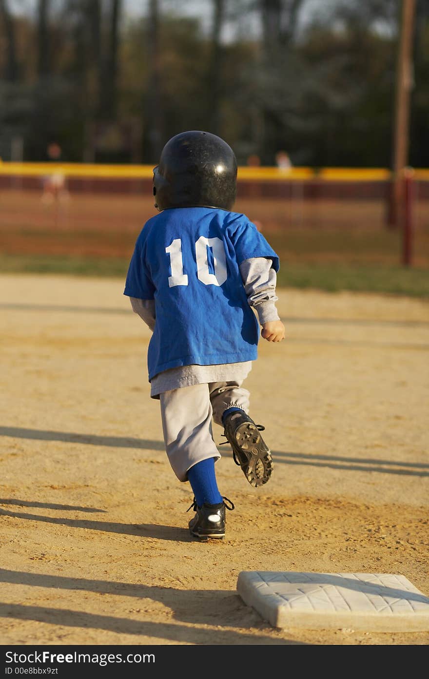 Young ball player in blue baseball uniform. Young ball player in blue baseball uniform