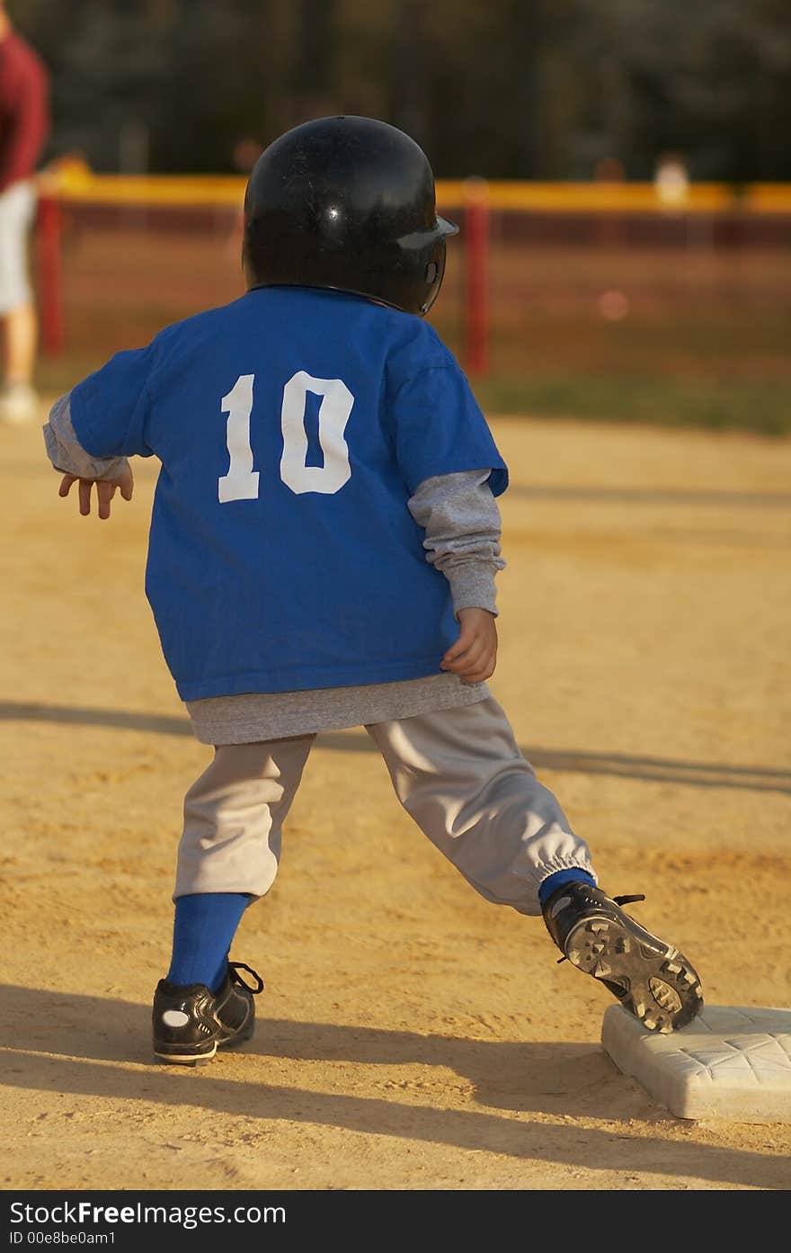 Young ball player in blue baseball uniform. Young ball player in blue baseball uniform