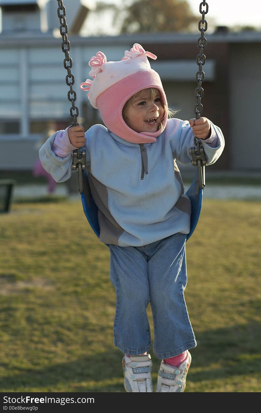 Pretty young blond girl on swing. Pretty young blond girl on swing