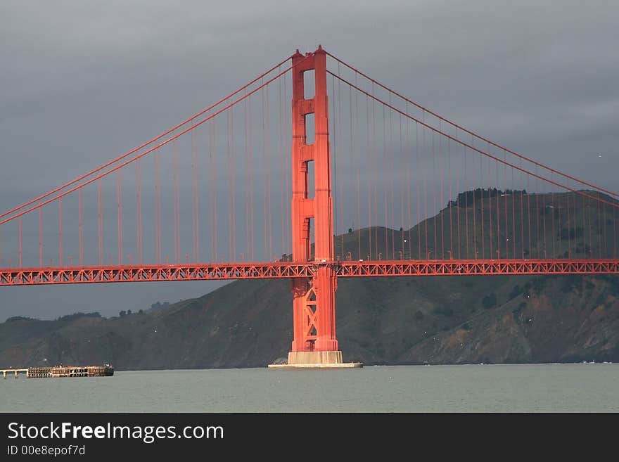 Golden Gate Bridge illuminated by sunlight on cloudy day, San Francisco