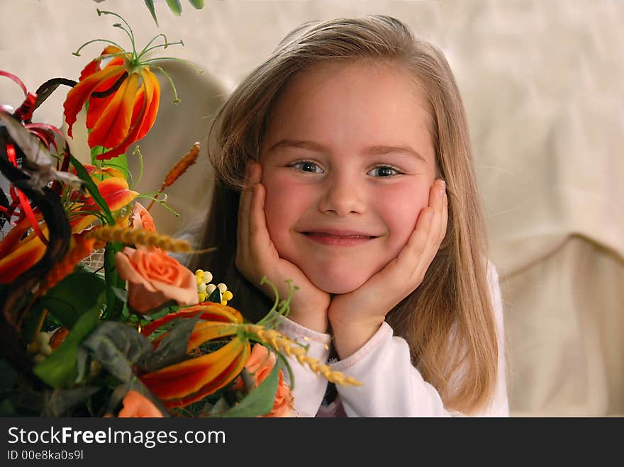 Portrait of a little girl next to a bunch of flowers