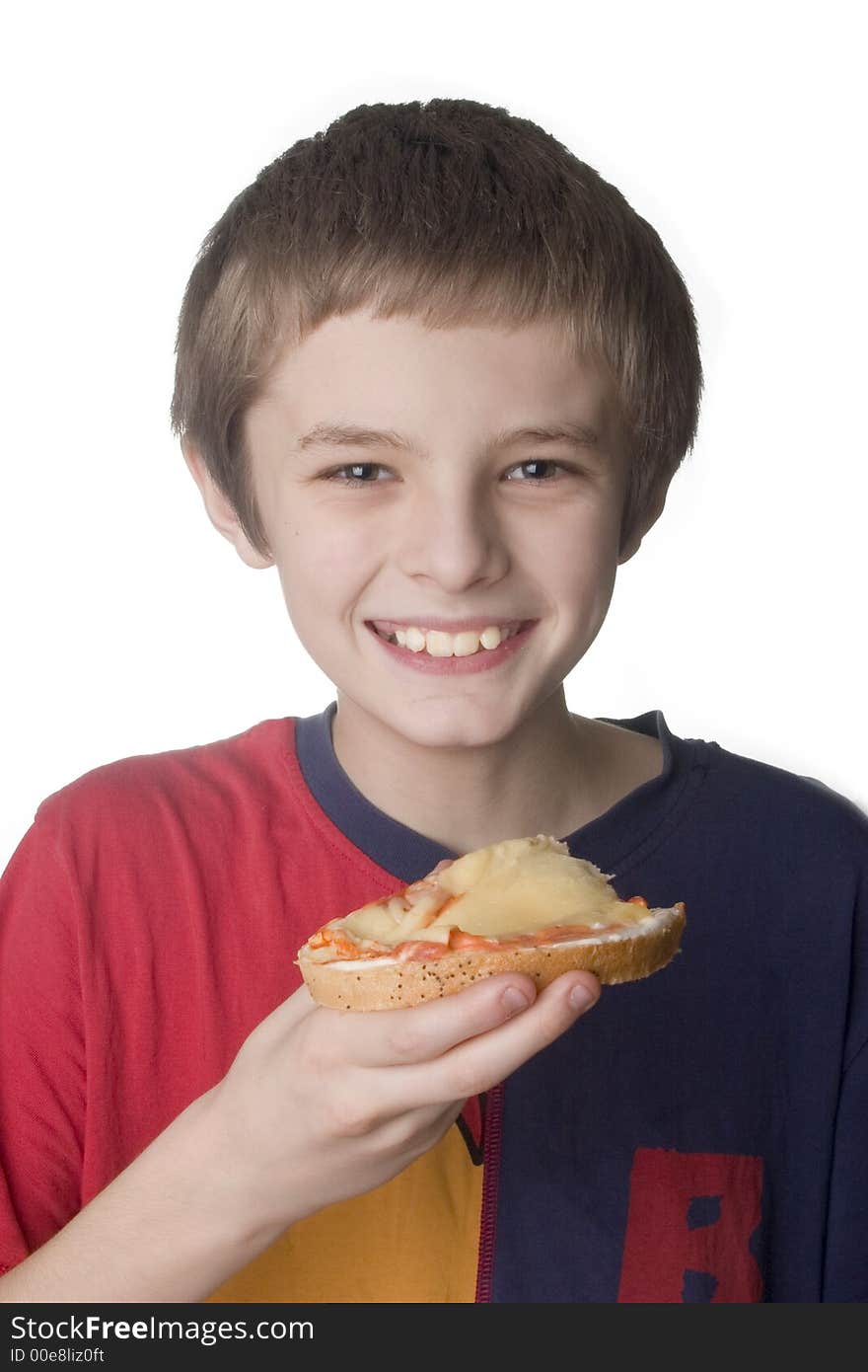 Smiling boy eating the sandwich on white backgro