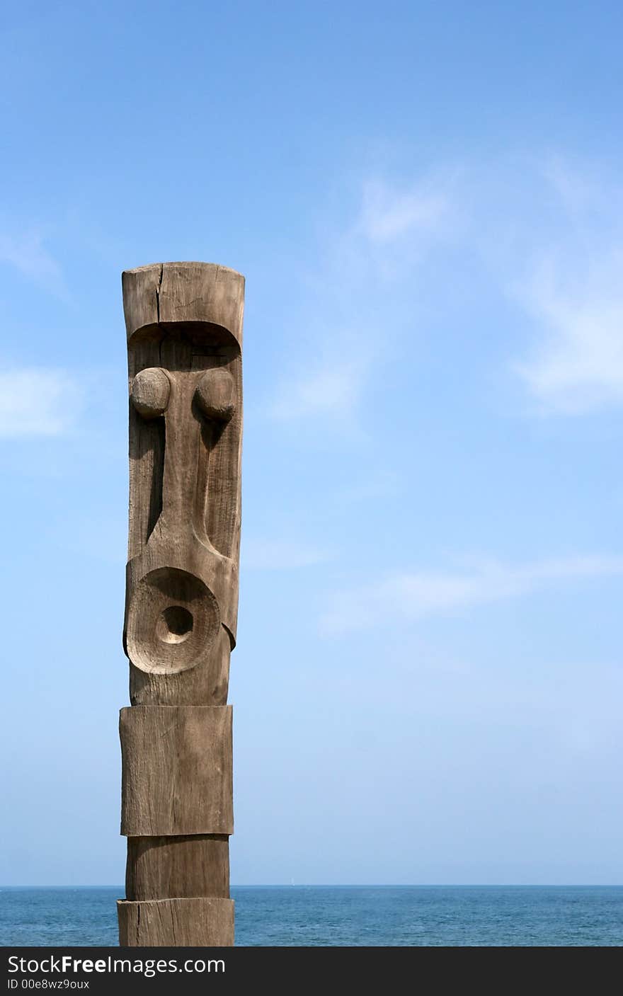 A wooden carved totem pole in france by the sea. A wooden carved totem pole in france by the sea