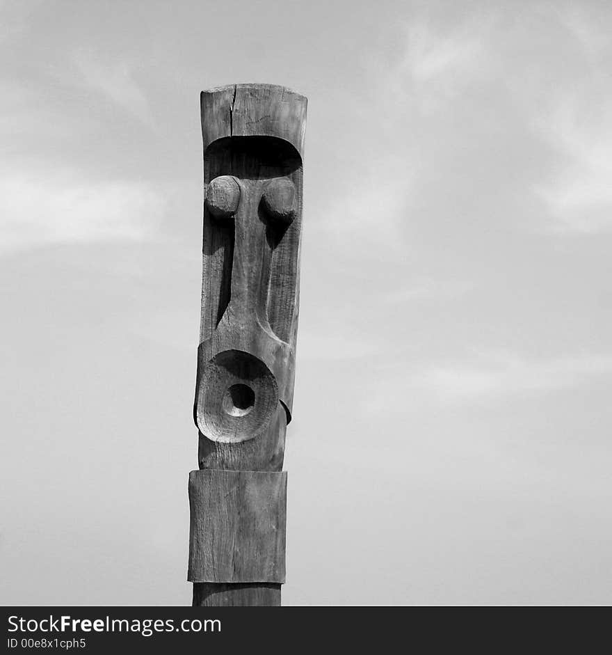 A wooden carved totem pole in france by the sea. A wooden carved totem pole in france by the sea