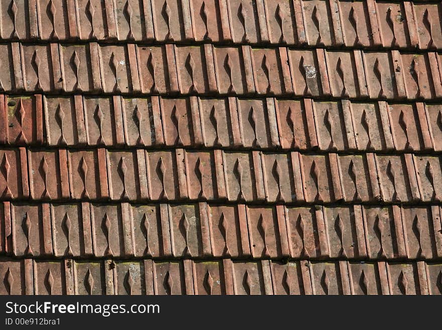 Detail of an old roof made with originally red tiles. Great texture. Detail of an old roof made with originally red tiles. Great texture.