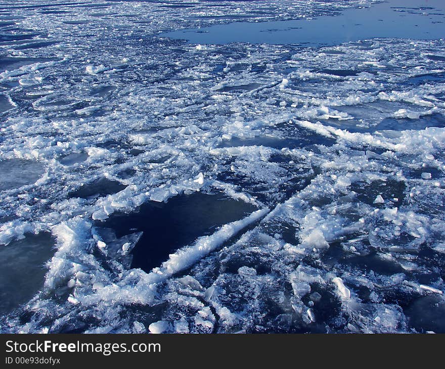 Ice melting in a river's water at spring time as a background. Ice melting in a river's water at spring time as a background.