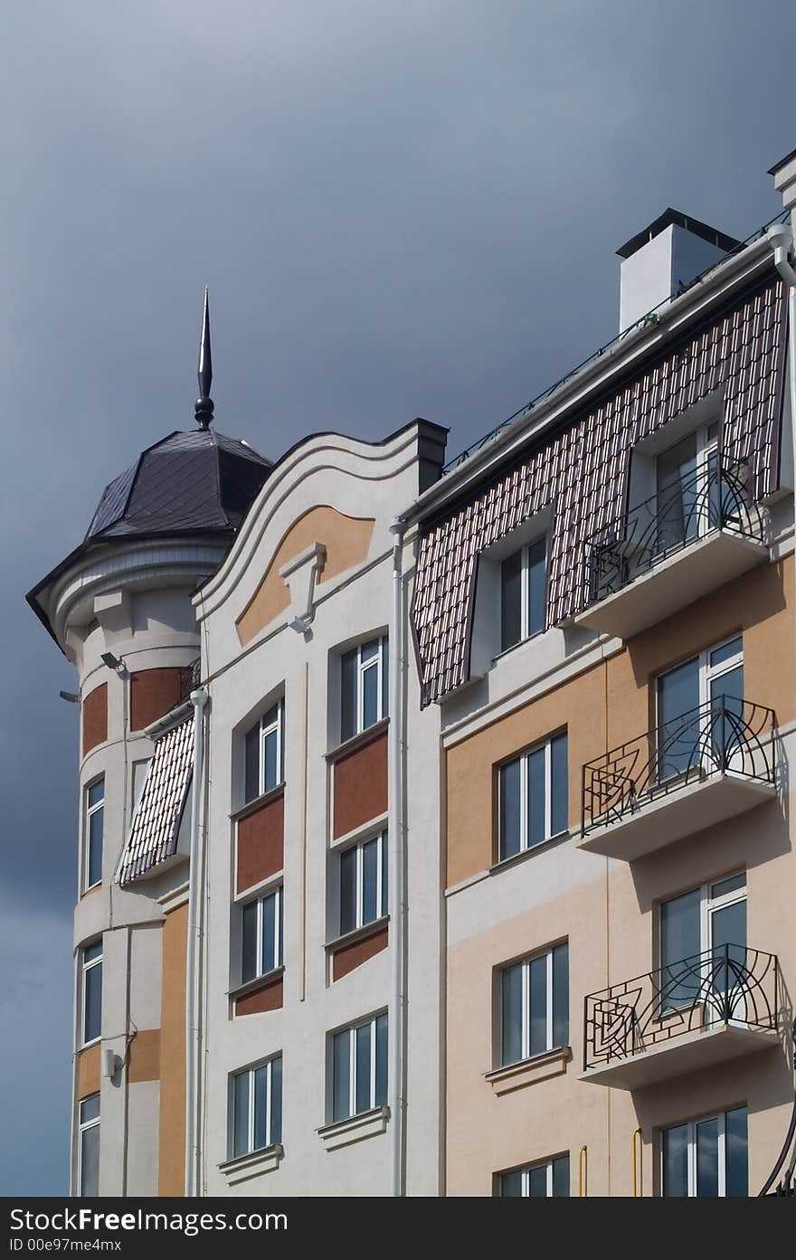 Modern classic building with balconies and tiled penthouse