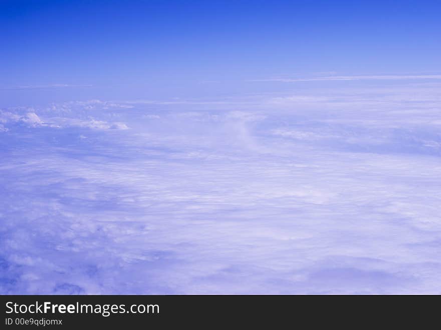 Light Clouds Background with clear horizon. Photo taken during flight travel