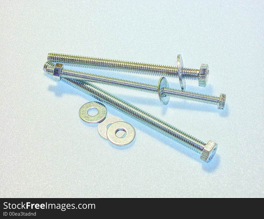 Three bolts laying on a white background