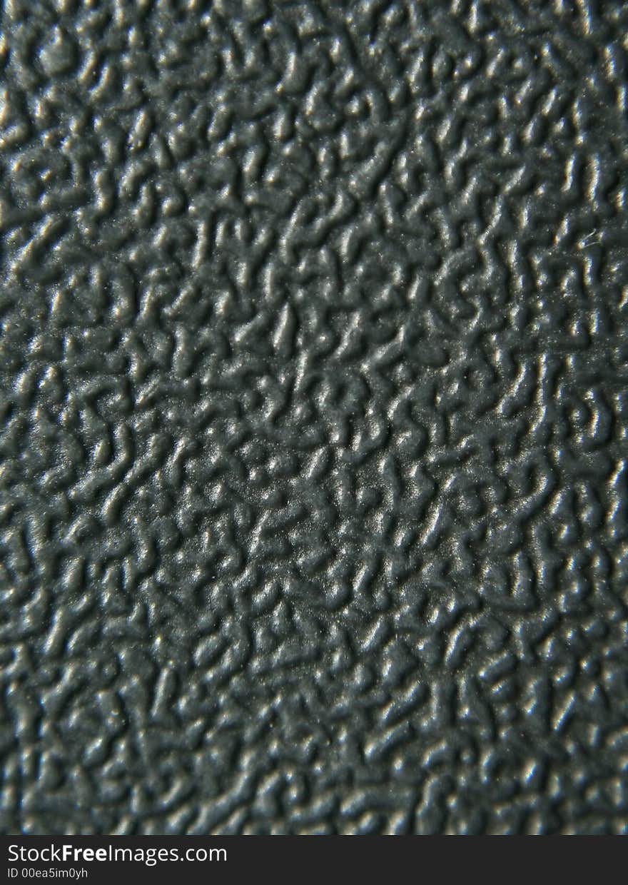 Close up on black textured plastic. The texture is curvy and smooth. Close up on black textured plastic. The texture is curvy and smooth.