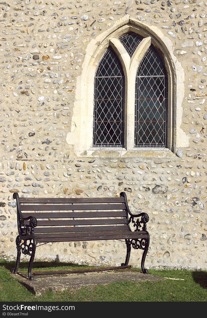 Old fashioned bench before a church. Old fashioned bench before a church