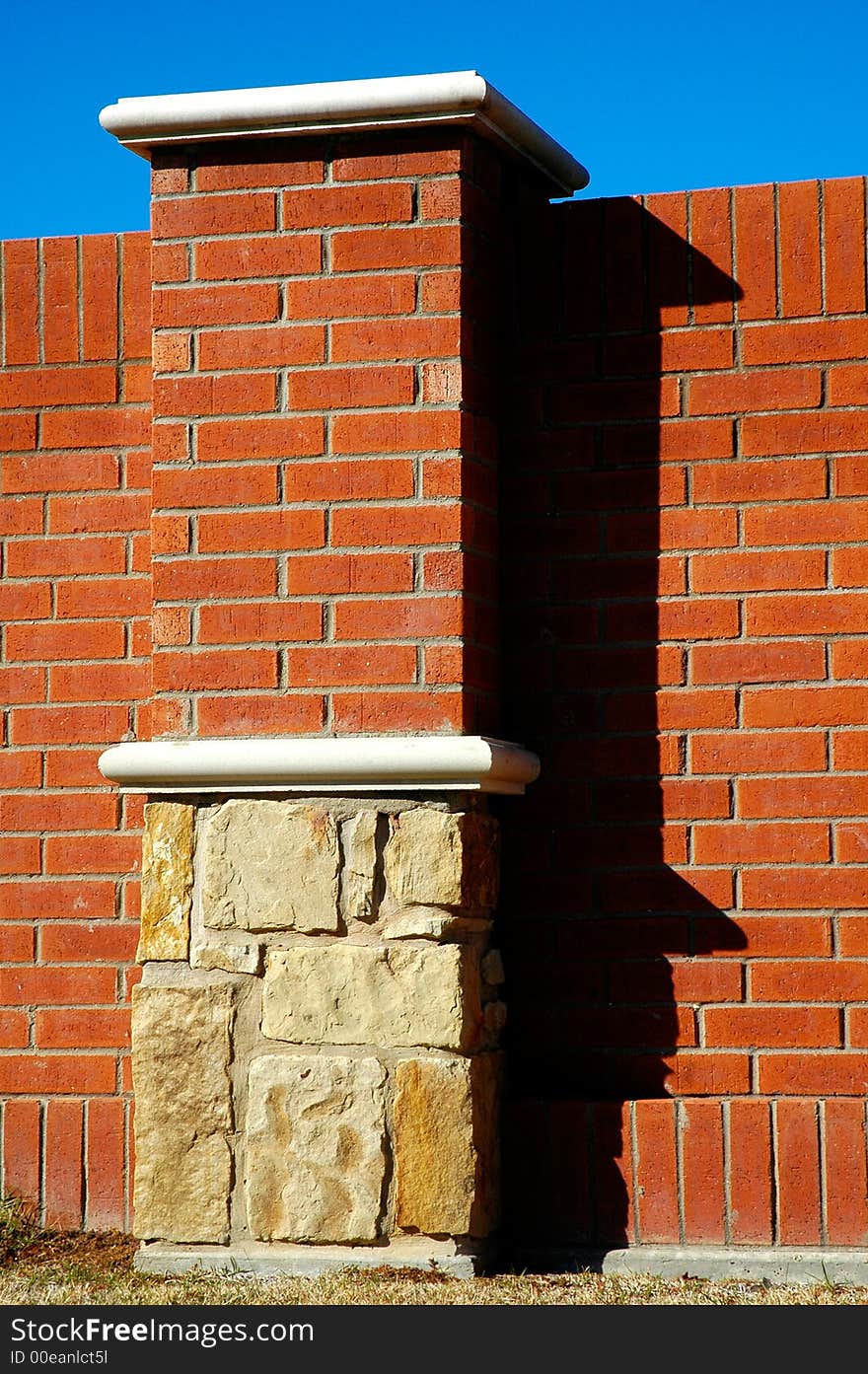 Column and wall made of bricks and stone. Column and wall made of bricks and stone