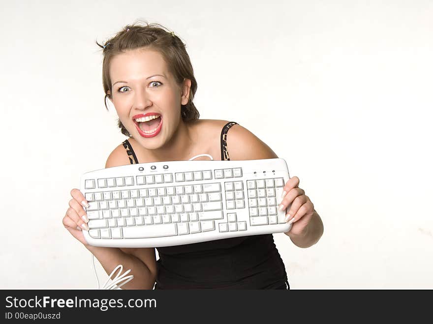 Excited pretty woman holding a keyboard. Excited pretty woman holding a keyboard