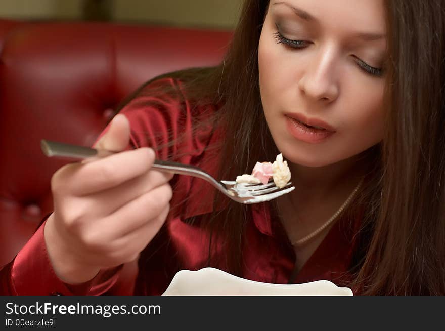 Beautiful brunette eats salad