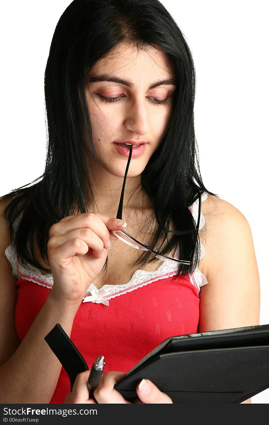 Beautiful young middle eastern woman with datebook and glasses. Beautiful young middle eastern woman with datebook and glasses.