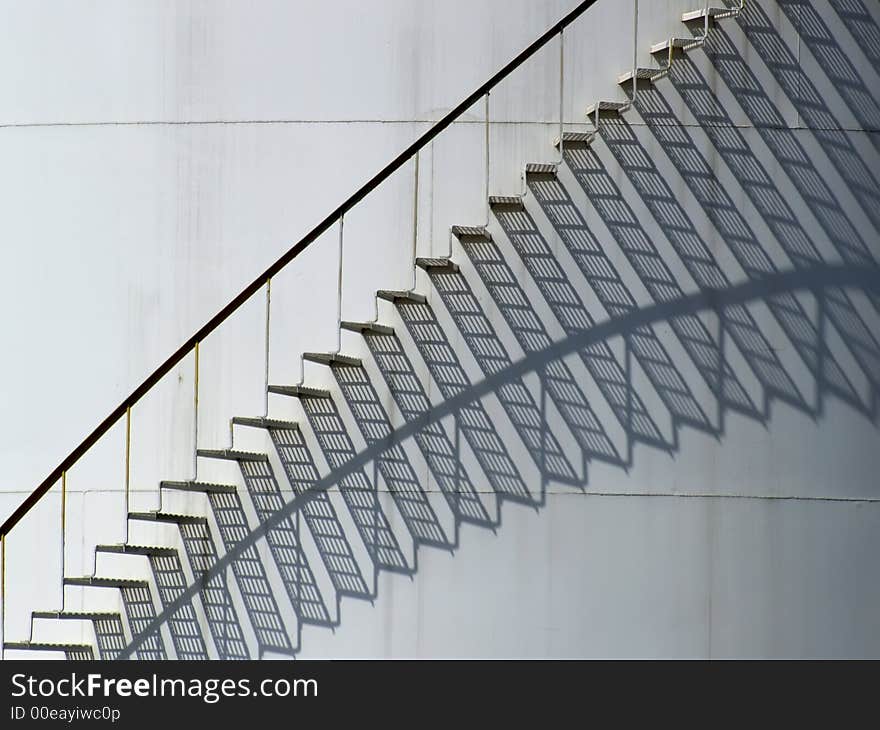 Stairs and shadows on a storage tank. Stairs and shadows on a storage tank.