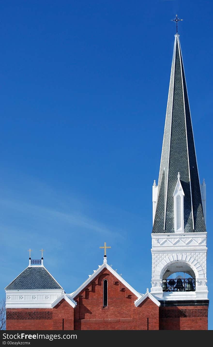 Church steeple and crosses against a blue sky