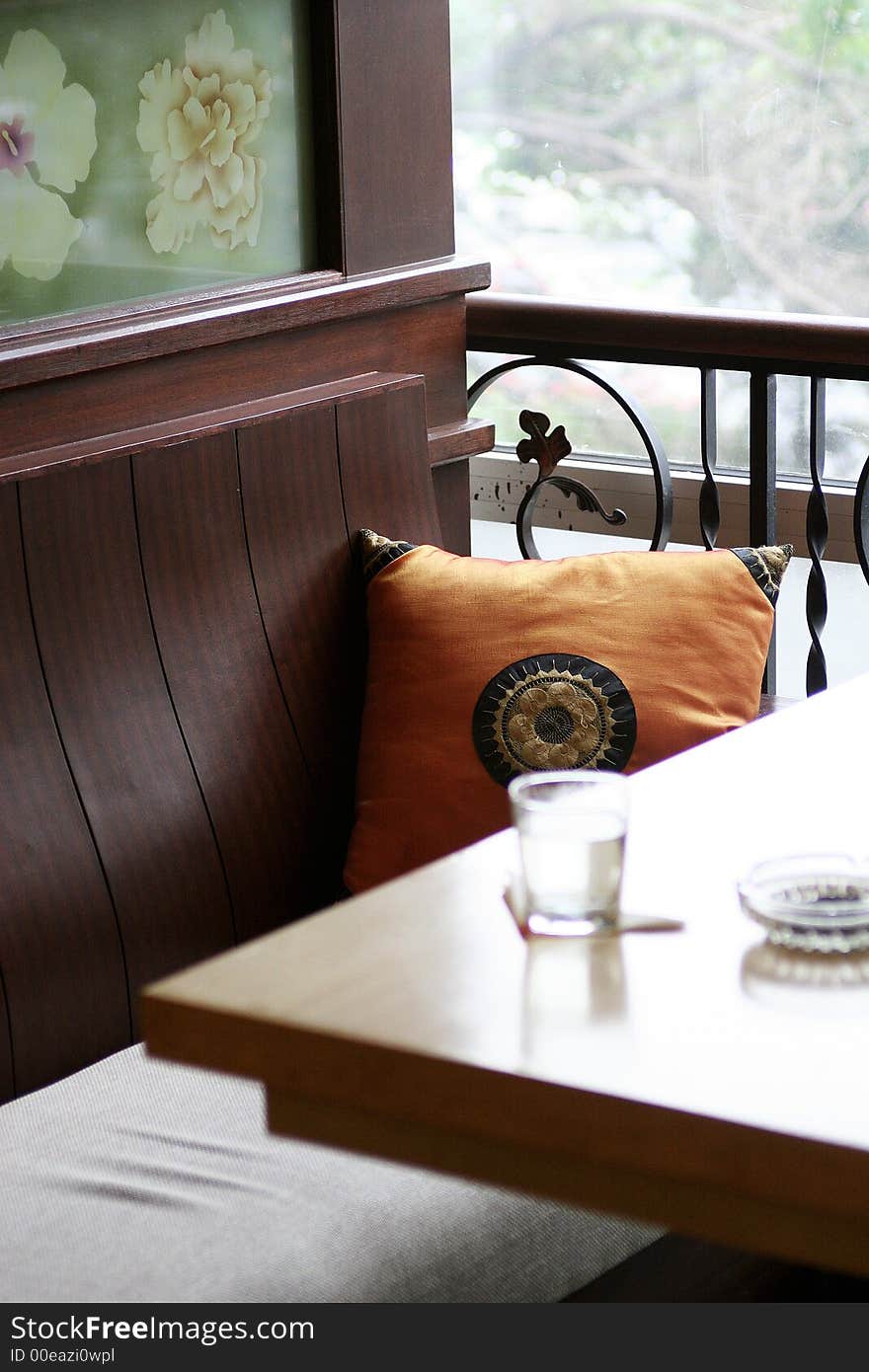 Glass and ashtray on table