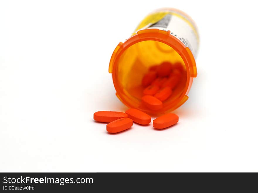 Closeup shot of Red and white pills against a white background