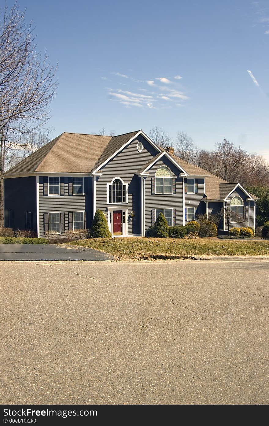 A beautiful colonial house on a bright sunny afternoon. A beautiful colonial house on a bright sunny afternoon