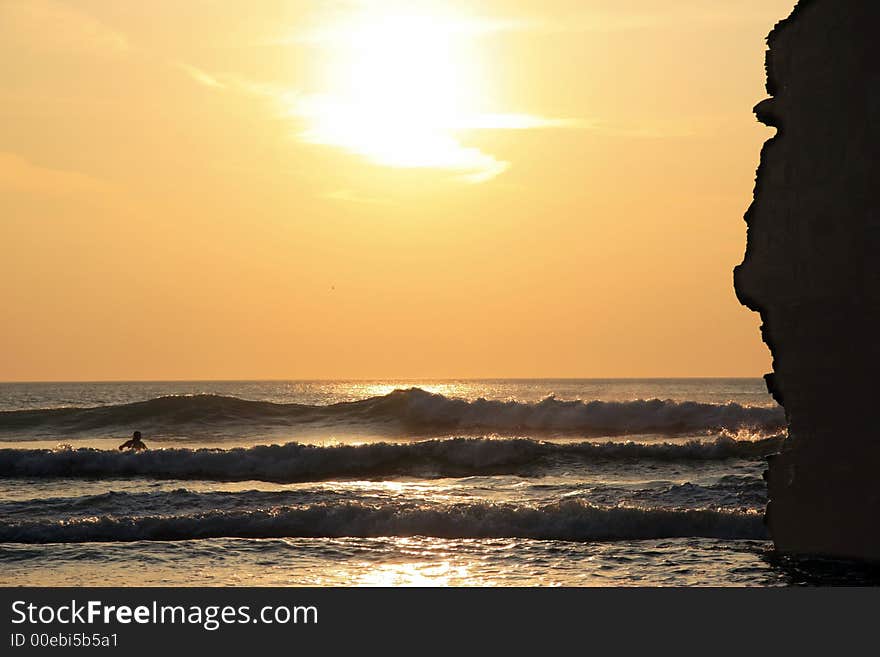 Lone surfer against irish cliffs. Lone surfer against irish cliffs