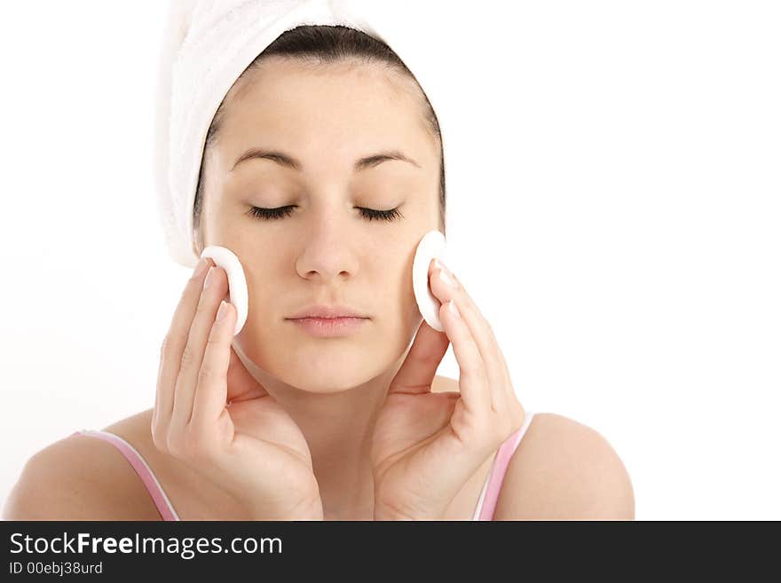 Young woman cleaning her face with cosmetic pads. Young woman cleaning her face with cosmetic pads