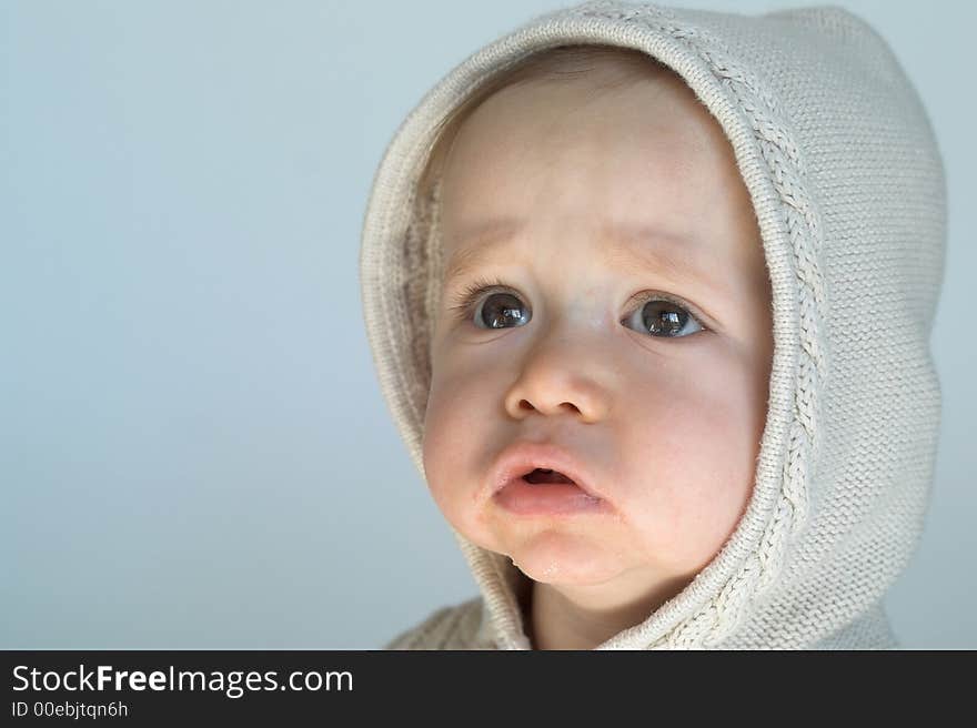 Image of cute baby wearing a hooded sweater. Image of cute baby wearing a hooded sweater