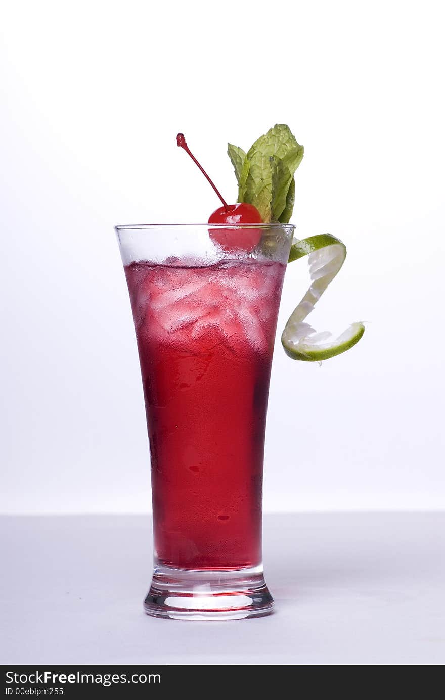 Colorful alcoholic cocktail in a tall glass against white background. Colorful alcoholic cocktail in a tall glass against white background