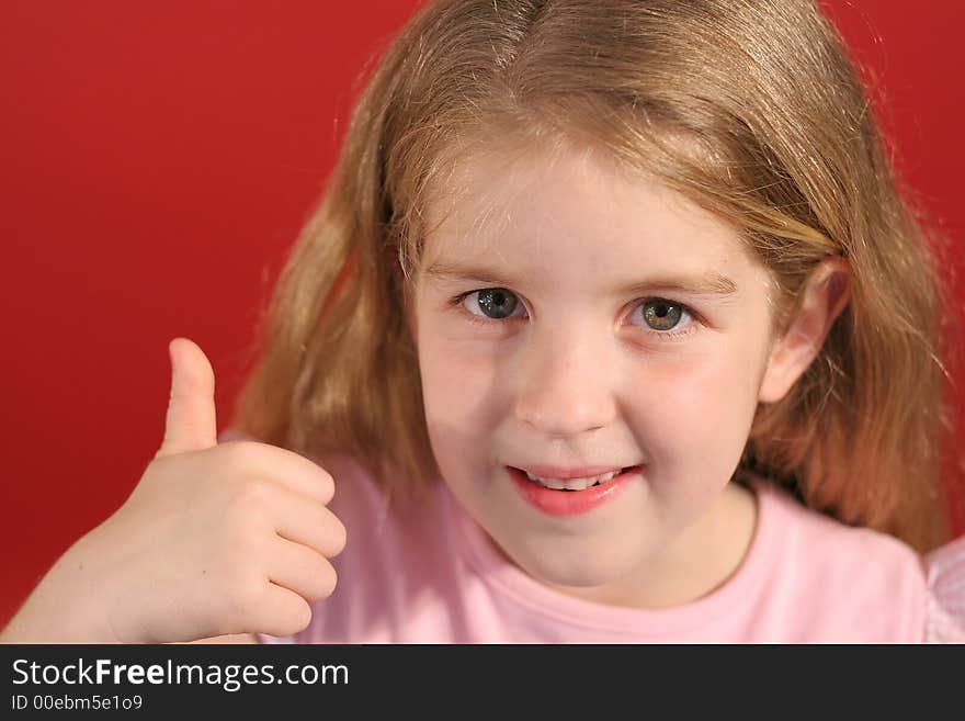 Shot of a little girl thumbs up