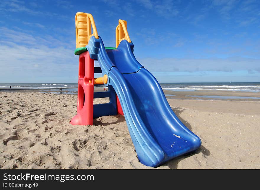 Plastic slide for small children on the beach. Plastic slide for small children on the beach