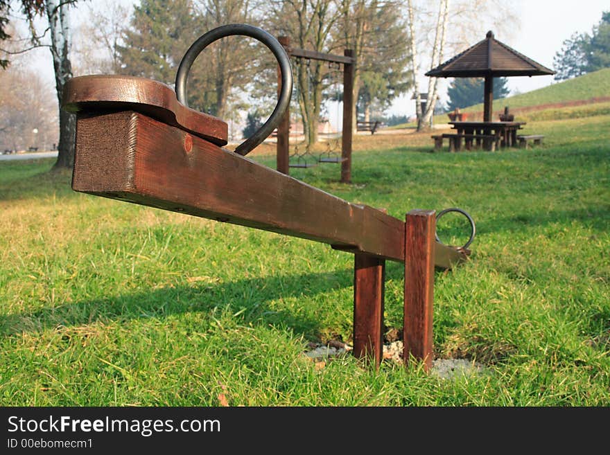 A wooden seesaw in a park