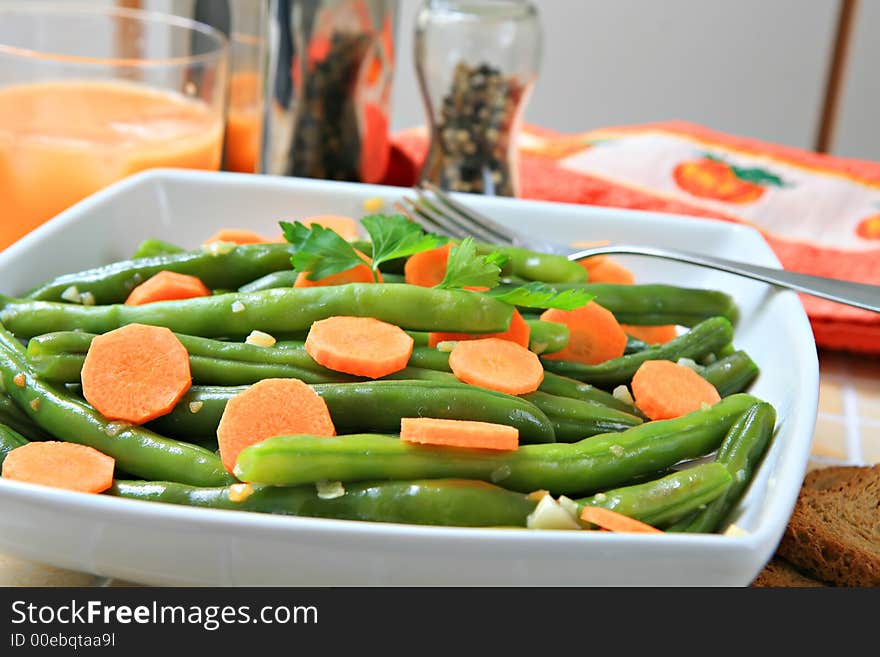 A bowl of stir fried green beans with garlic