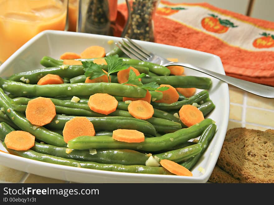 A bowl of stir fried green beans with garlic