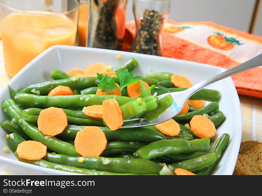 A bowl of stir fried green beans with garlic