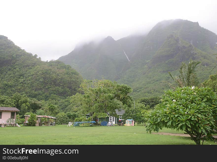 House tucked away against the mountains of Kauai island, in Hawaii. House tucked away against the mountains of Kauai island, in Hawaii.