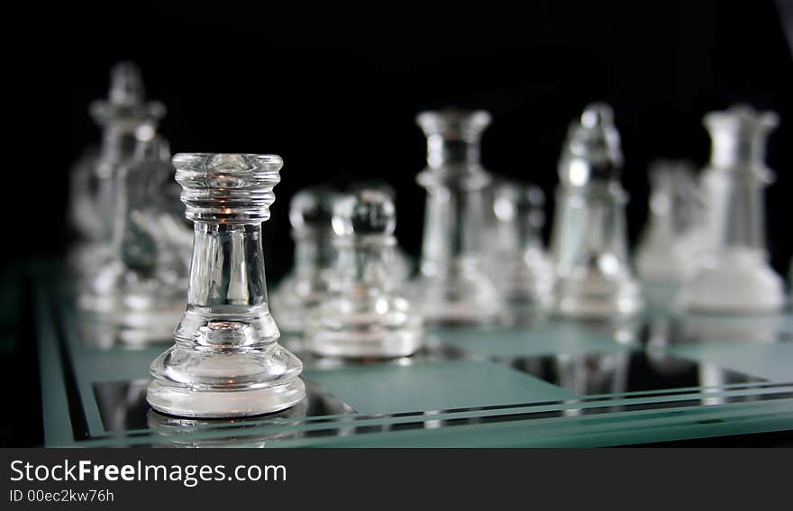 Glass Chess Pieces on a Frosted Glass Chess Board. Glass Chess Pieces on a Frosted Glass Chess Board