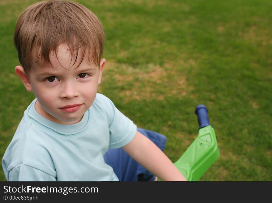 Sight of the child at a background of a green grass