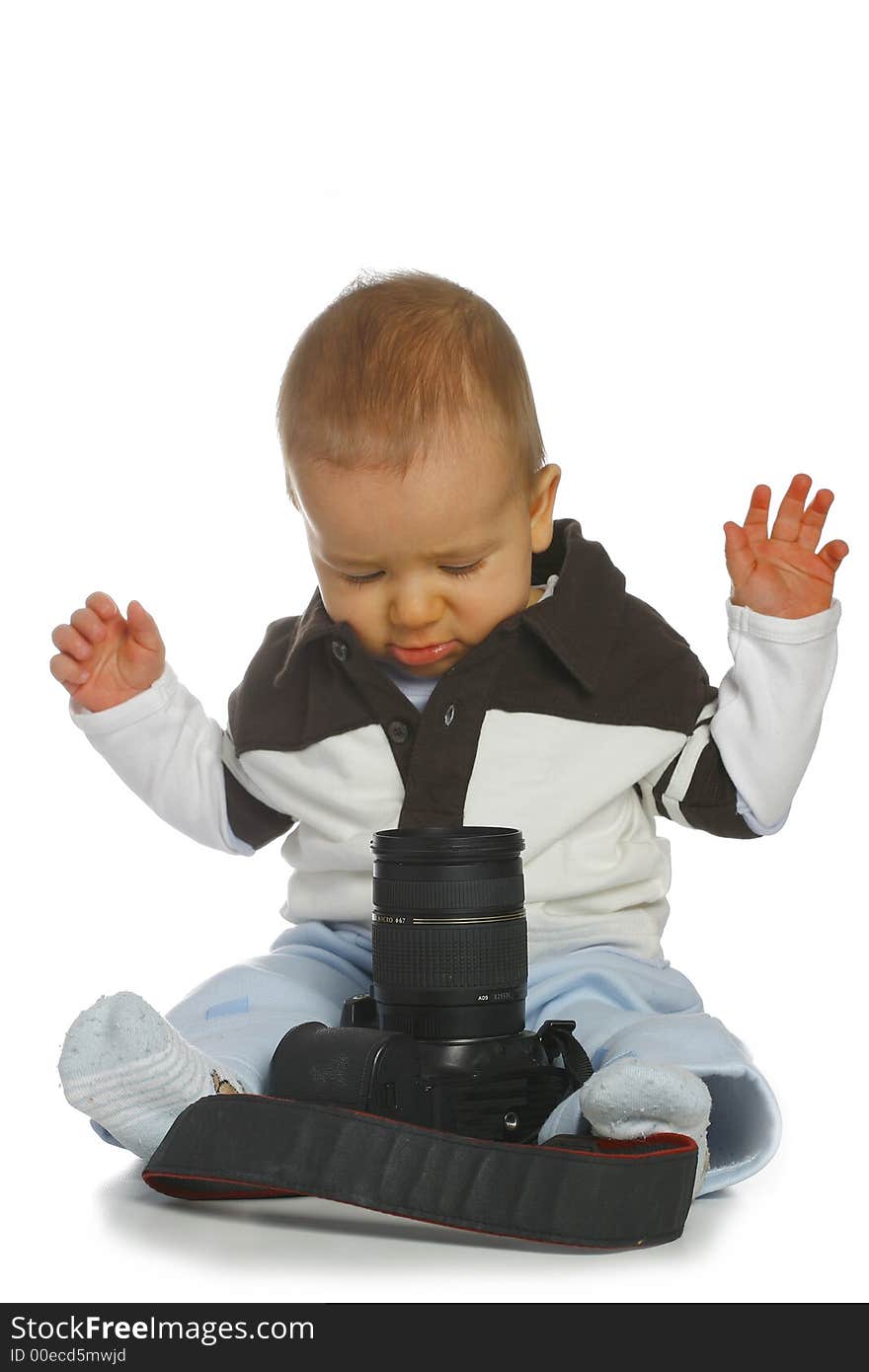 A small boy wearing blouse and trousers with camera. A small boy wearing blouse and trousers with camera