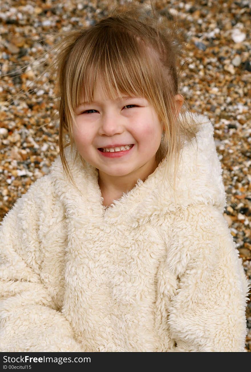 Young girl on a stoney beach. Young girl on a stoney beach