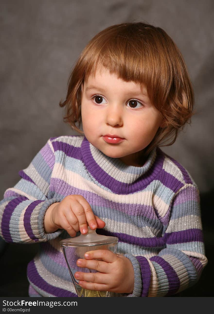 Portrait of the two-year-old girl with a bottle in hands. Portrait of the two-year-old girl with a bottle in hands