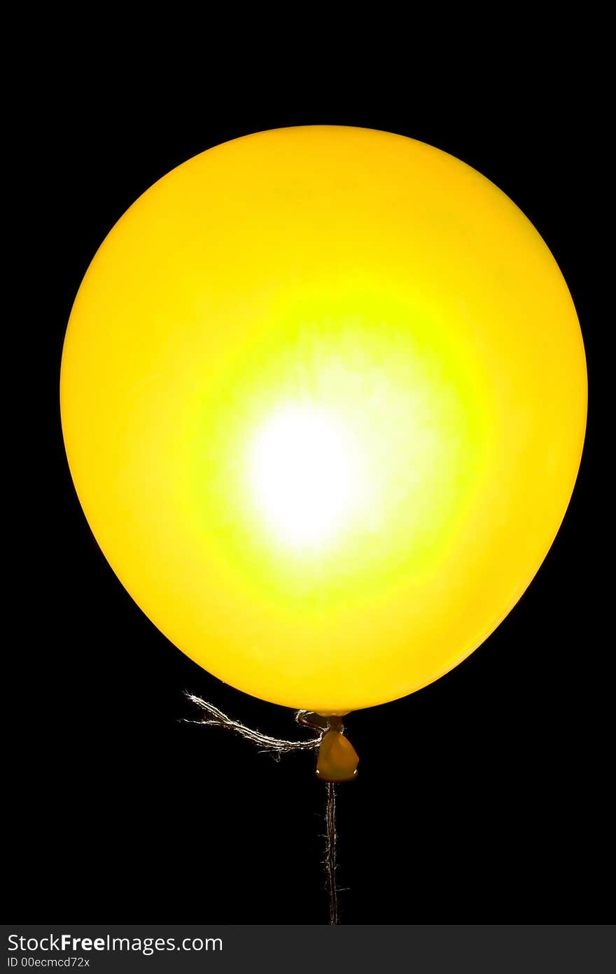 Yellow balloon on a string backlight isolated on black. Yellow balloon on a string backlight isolated on black