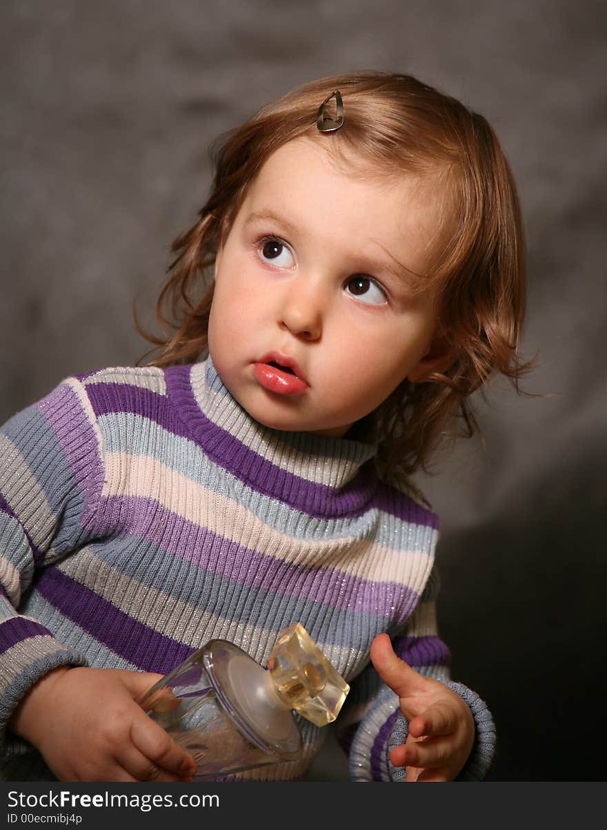 Portrait of the two-year-old girl with a bottle in hands. Portrait of the two-year-old girl with a bottle in hands