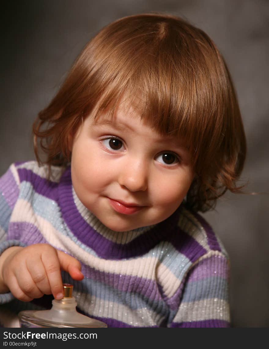 Portrait of the two-year-old girl with a bottle in hands. Portrait of the two-year-old girl with a bottle in hands