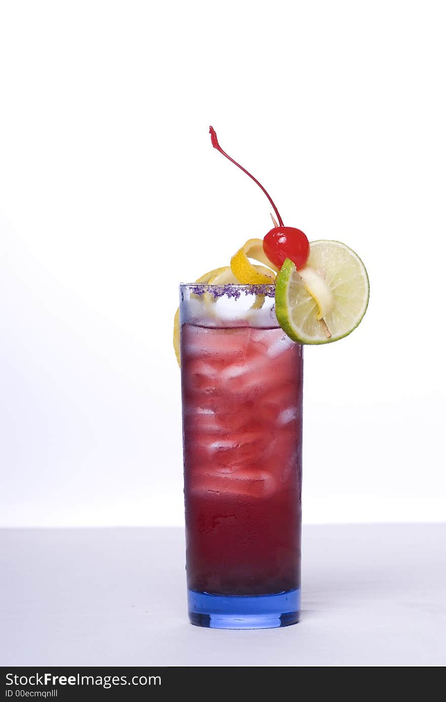 Colorful alcoholic cocktail in a tall glass against white background. Colorful alcoholic cocktail in a tall glass against white background