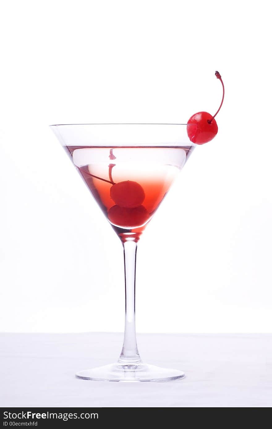 Colorful alcoholic cocktail in a martini glass against white background. Colorful alcoholic cocktail in a martini glass against white background