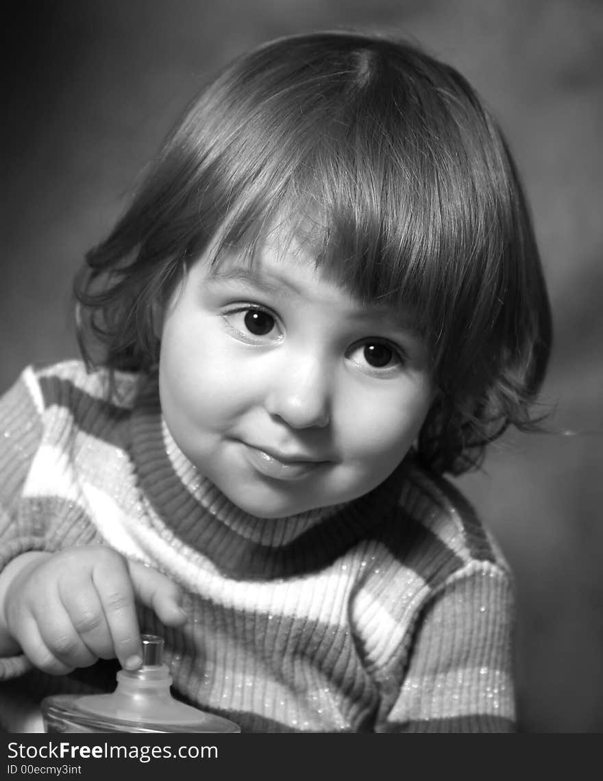 Portrait of the two-year-old girl with a bottle in hands. b/w. Portrait of the two-year-old girl with a bottle in hands. b/w