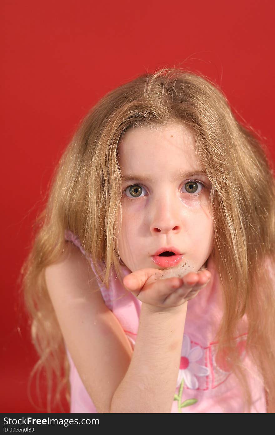 Little girl blowing flowers