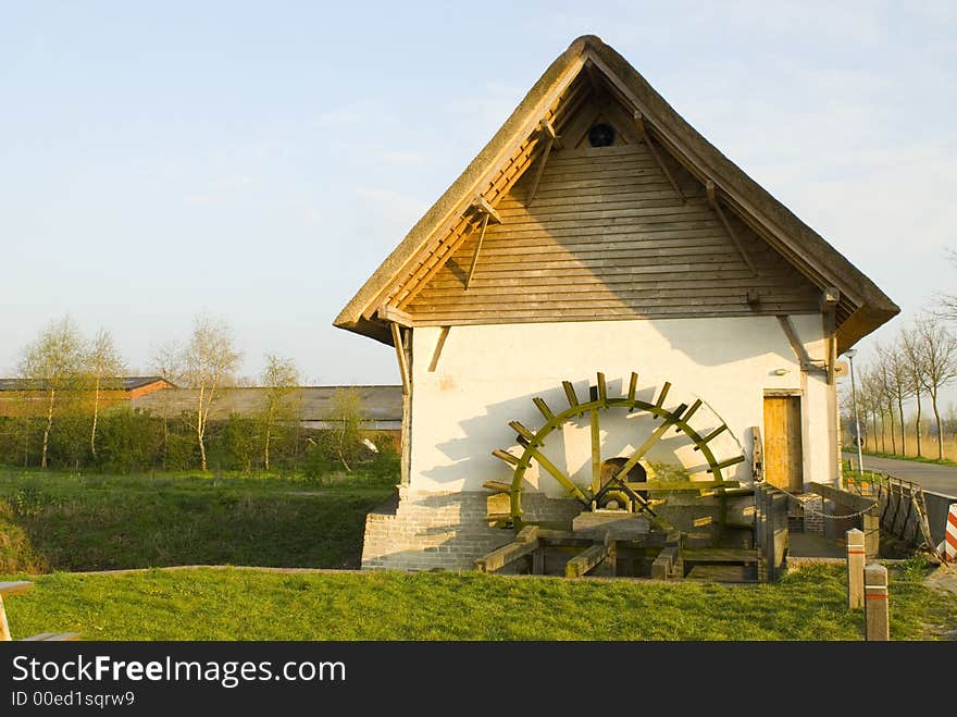 Old watermill in springtime landscape