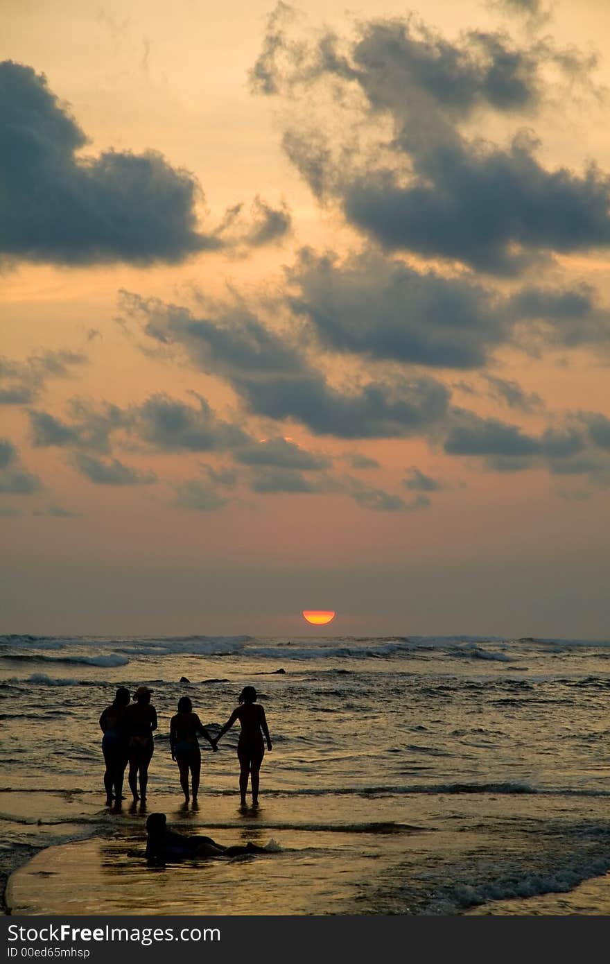 A salt water pool at high tide makes it look like people are walking on water.