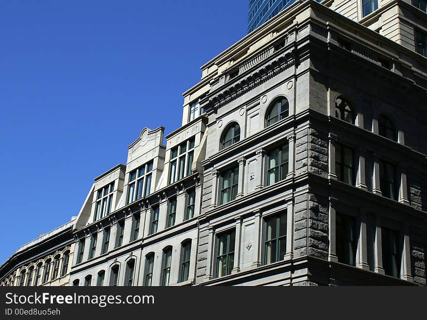 Old stately building in downtown boston against a deep blue sky